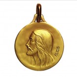 Médaille christ en or, argent et plaqué or